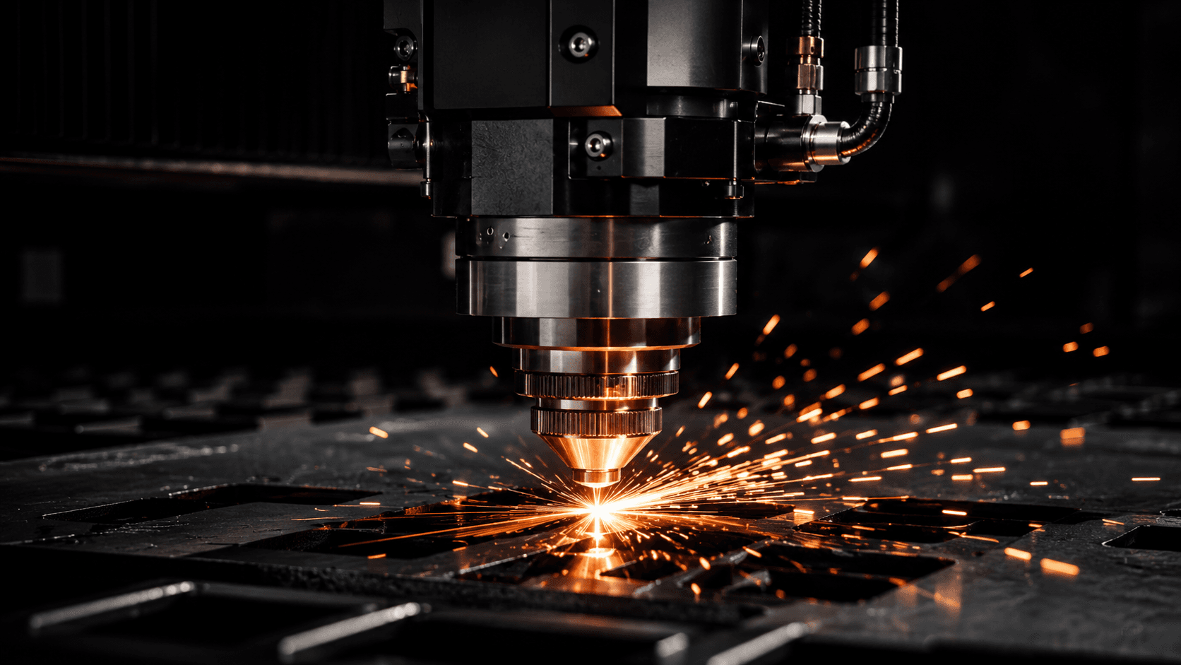 Fiber laser cutting head cutting sheet metal, sparks flying as it cuts